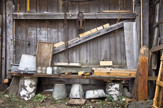 Old rustic fence off the bench. Old trash and debris. Rural life