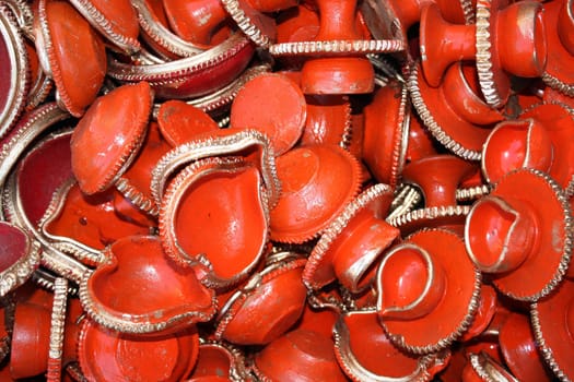 A background of red traditional lamps made of clay for Diwali festival.
