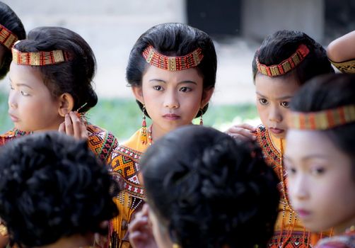 Children dressed with traditional toraja clothes during a funeral ritual in Indonesian village on 15th August 2010