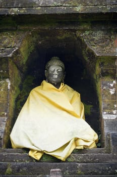 Buddha statue covered with a yellow blanket