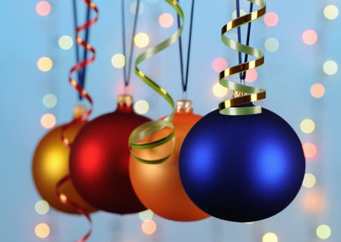 multicoloured christmas-tree decorations on blue background