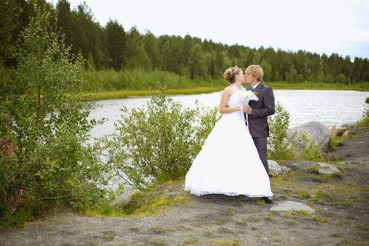 The bride and groom on the nature of the pond