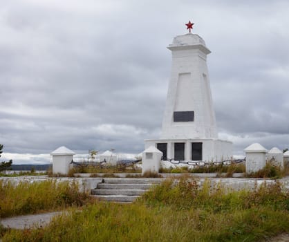 Soviet vintage old concrete gray monument with red star