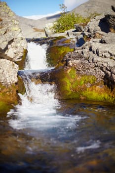 Alpine waterfall on a small transparent pure stream