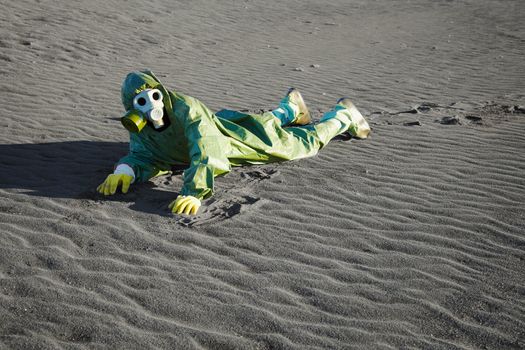 Man in chemical suits and gas masks crawling on the poisoned soil