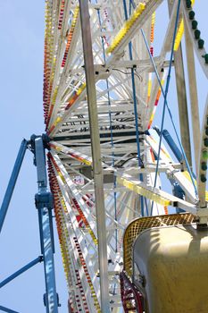 Carnival ferris wheel with blue sky background