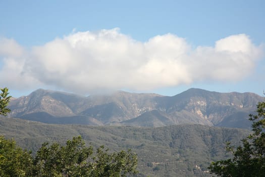 Mountains with cloudy and brilliant blue sky