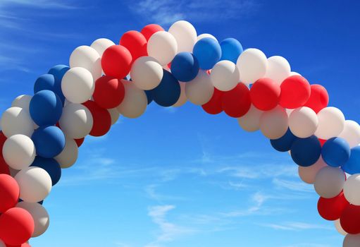 Red white and blue patriotic balloons on pretty blue sky