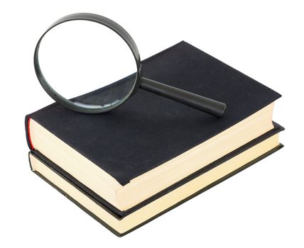 Two black books and magnifier glass on white background
