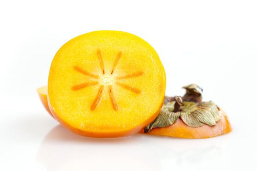 Slice of fresh persimmon on white background