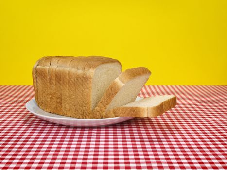 A loaf of sliced bread served on a platter.