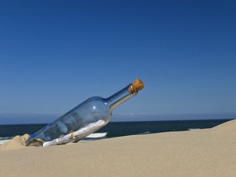 A bottle with a message inside is buried on the beach.