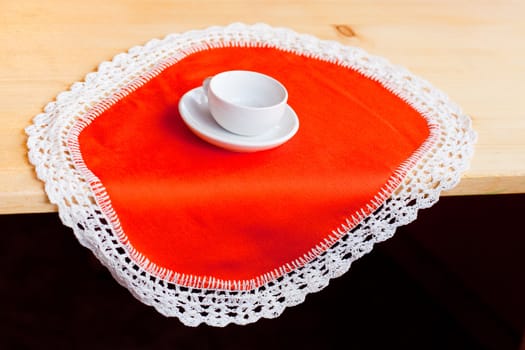 A coffee cup on an orange napkin
