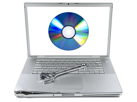 Damaged laptop with a spanner over it and a digital disc on the screen. Isolated on white.