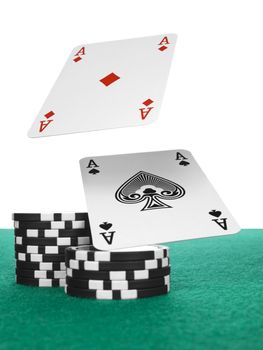 Two aces flying over a stack of chips on the poker table.
