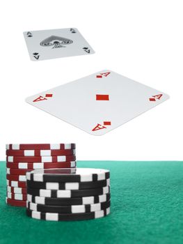 Two aces flying over the poker table. Red and black chips on the foreground.