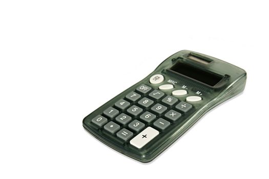 Simple gray calculator placed at an angle, isolated on white. Focus on nearest corner.