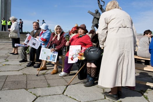 RIGA, LATVIA, MAY 9, 2008: Old women Celebrating May 9 Victory Day (Eastern Europe) in Riga at Victory Memorial to Soviet Army