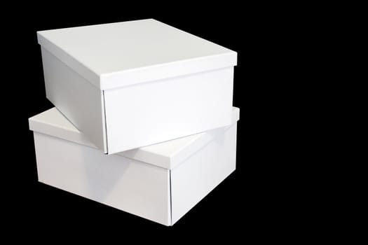 Two crisp white cardboard boxes isolated on black background