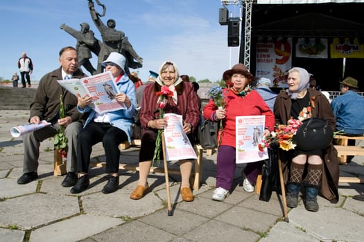 RIGA, LATVIA, MAY 9, 2008: Old women Celebrating May 9 Victory Day (Eastern Europe) in Riga at Victory Memorial to Soviet Army