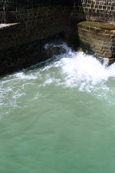 Waves crashing against a costal wall in Brighton.

