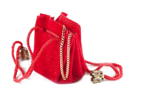 A little red bag with golden chain inside isolated over white