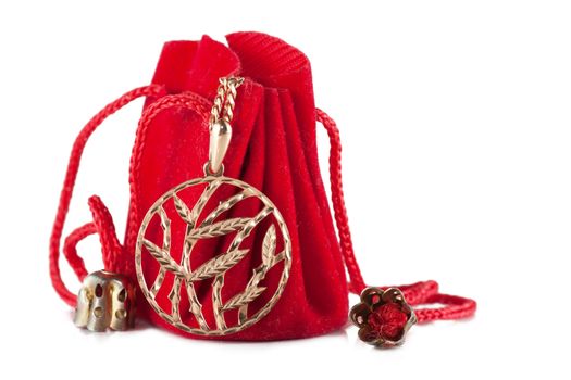 A little red bag with golden pendant isolated over white