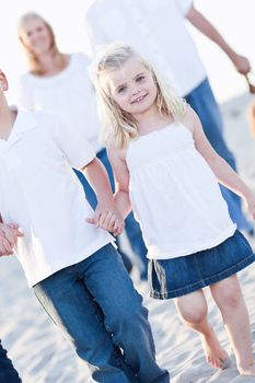 Adorable Little Girl Walking With Her Family at the Beach.