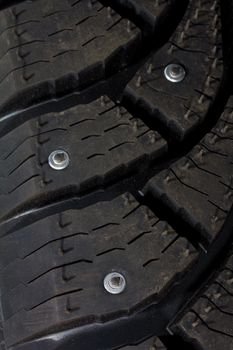 close-up new snow tire with studs