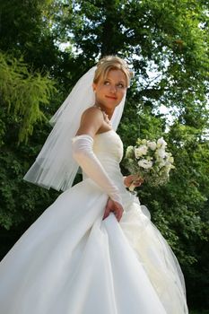 The image of the bride walking on park