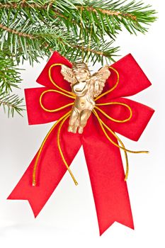 Christmas decoration angel on spruce branch. Isolated on a white background.