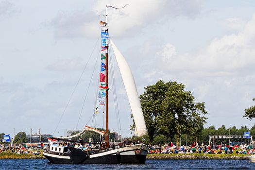 SAIL AMSTERDAM 2010 -IJMUIDEN, THE NETHERLANDS - AUGUST 2010: Sail 2010 starts with the spectaculair Sail-in Parade.  50 Tall ships and more than 500 of  naval ships, replicas and yachts sail in convoy through the North Sea Canal from IJmuiden to Amsterdam. Thousands of private boats accompany the fleet and more than 300.000 visitors watch the parade from the banks. August 19, 2010, IJmuiden, the Netherlands