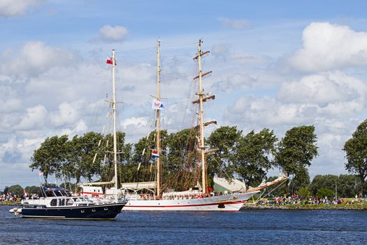 SAIL AMSTERDAM 2010 -IJMUIDEN, THE NETHERLANDS - AUGUST 2010: Sail 2010 starts with the spectaculair Sail-in Parade.  50 Tall ships and more than 500 of  naval ships, replicas and yachts sail in convoy through the North Sea Canal from IJmuiden to Amsterdam. Thousands of private boats accompany the fleet and more than 300.000 visitors watch the parade from the banks. August 19, 2010, IJmuiden, the Netherlands