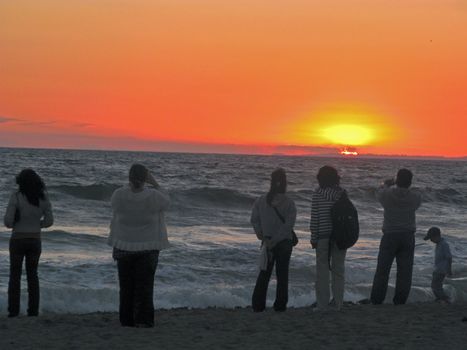 an isolated shot of People watching Sunset