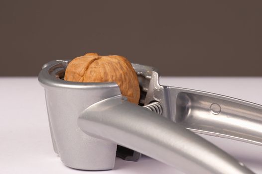 Nutcracker in the design of a clamp with a walnut inside