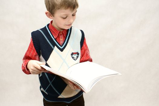 young boy with book in white background