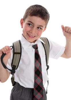 Happy young smiling schoolboy child wearing a uniform and carrying a backpack.  White background.