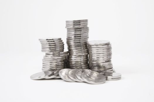 Stacks of silver coins on white background