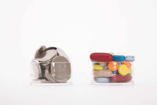 money and colored pills on white background