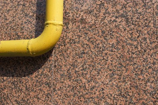 front view of yellow pipe on marble background