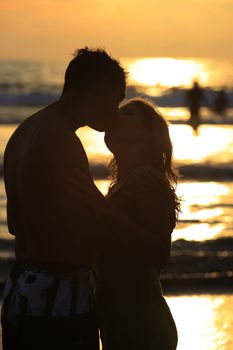 Silhouette to the in love pair on a sunset