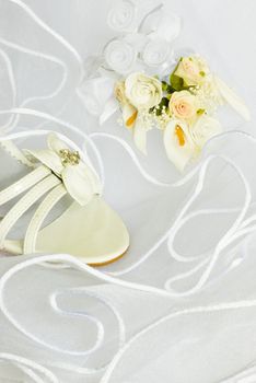 wedding sandals and flowers decoration over bridal veil