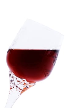 Red wine in an elegant glass inclined at a small angle. It is isolated on a white background.Hand made clipping path inside
