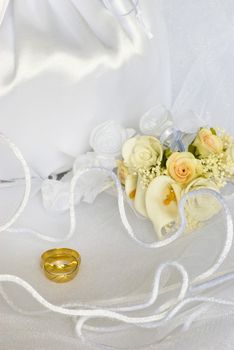 bridal bag and wedding rings flowers decorations over bridal veil