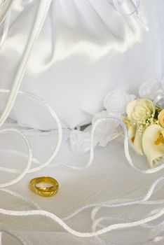 bridal bag and wedding rings flowers decorations over bridal veil