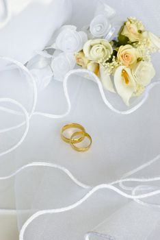 bridal bag and wedding rings flowers decorations over bridal veil