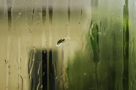 Condensation on glass with running water drops