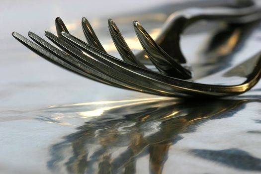 Closeup of forks on reflective surface