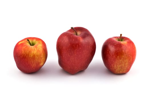 Three red apples on white background