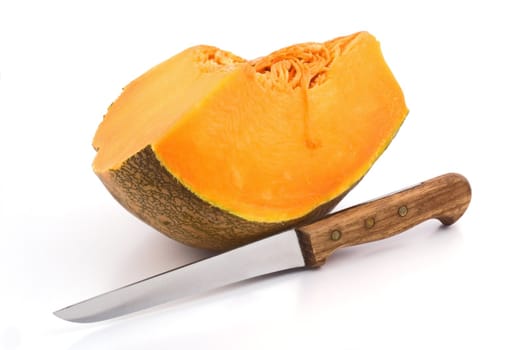 Slice of pumpkin with knife on white background